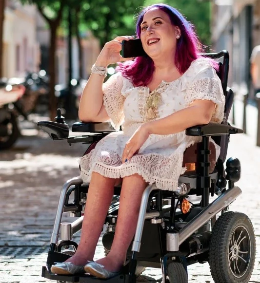 Disabled woman in wheelchair using a smartphone